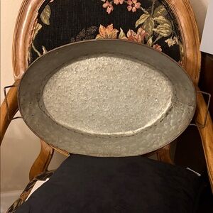 Galvanized Distressed Metal Oval tray with handles and hammered finish.